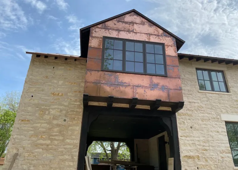 Copper metal panel facade on a stone building for Skylight Installation in Peoria Heights
