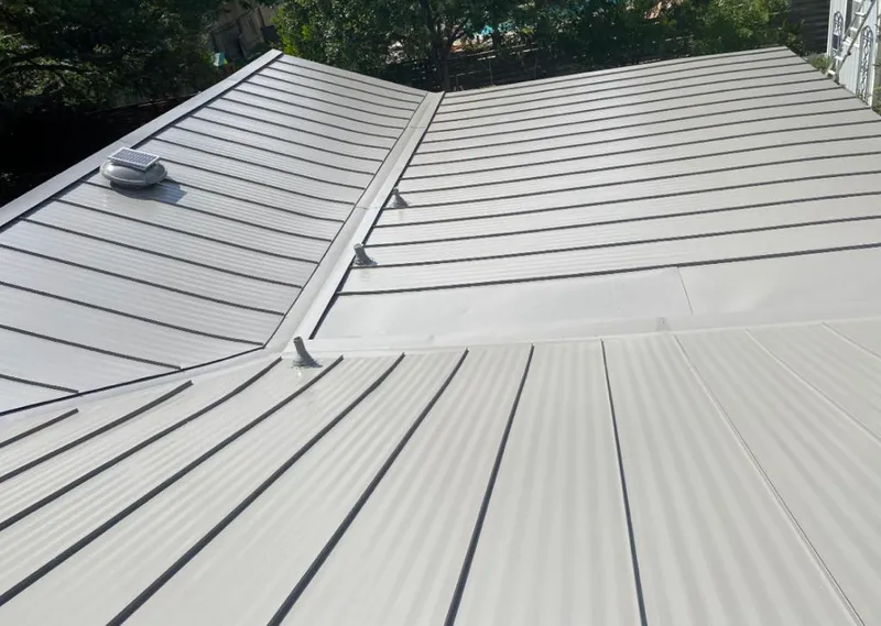 Solar attic fan installed on a metal roof for Roof Ventilation in Peoria Heights